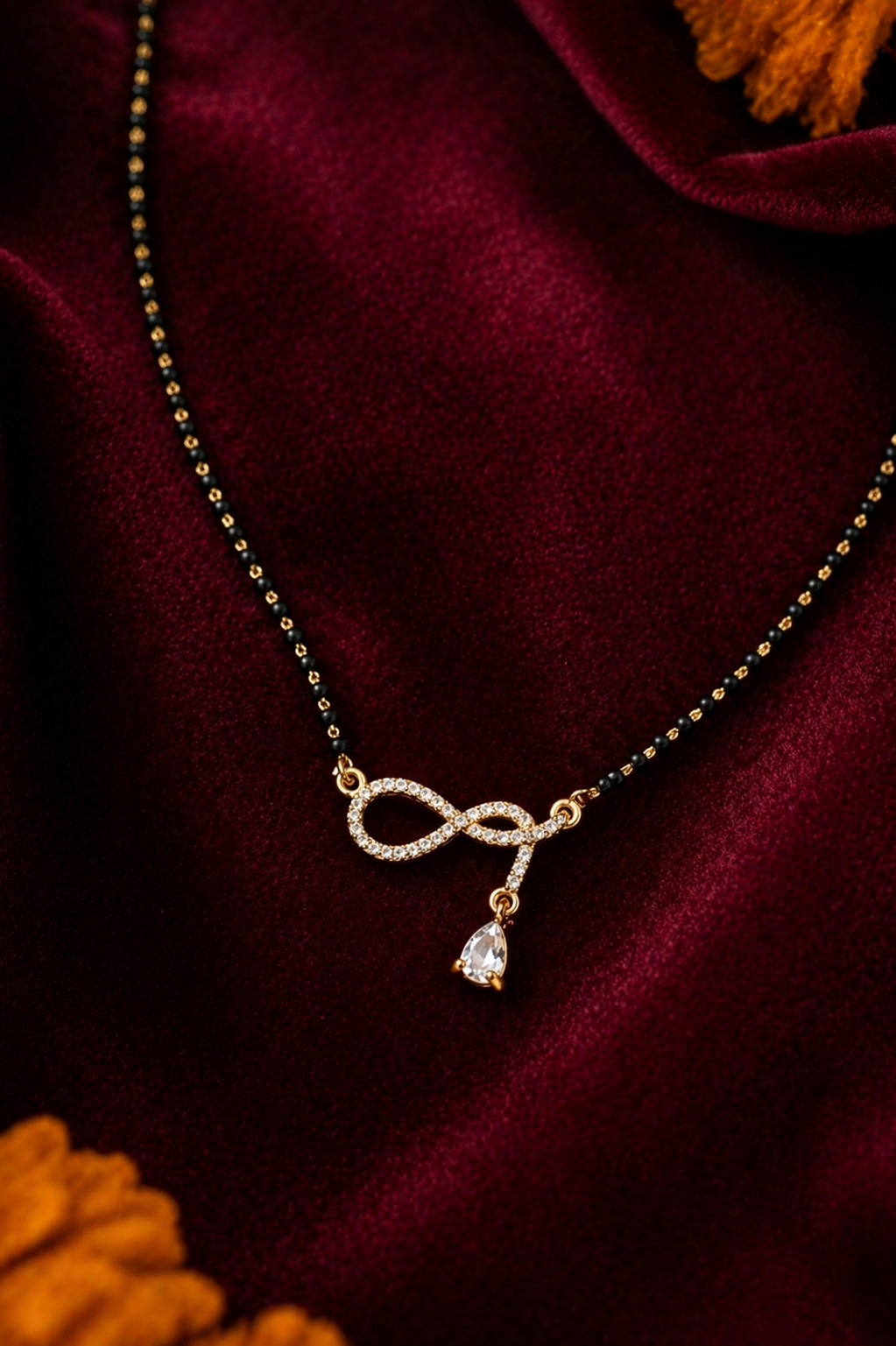 Gold plated infinity loop mangalsutra with pave-set cubic zirconia stones and pear drop dangler from Forever Shine