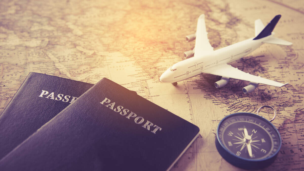 Coronavirus travel vaccinations - passport, plane, compass and map - Fruit-Powered